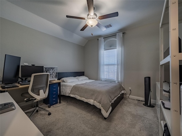 carpeted bedroom with ceiling fan and vaulted ceiling