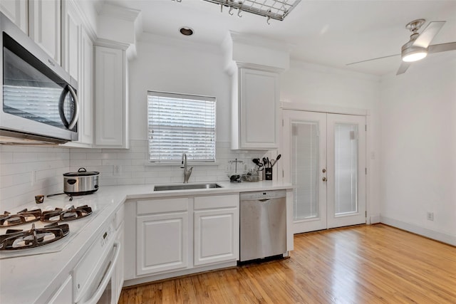 kitchen with sink, appliances with stainless steel finishes, and white cabinets