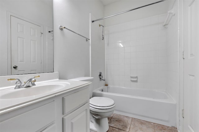 full bathroom with tile patterned flooring, vanity, tiled shower / bath, and toilet