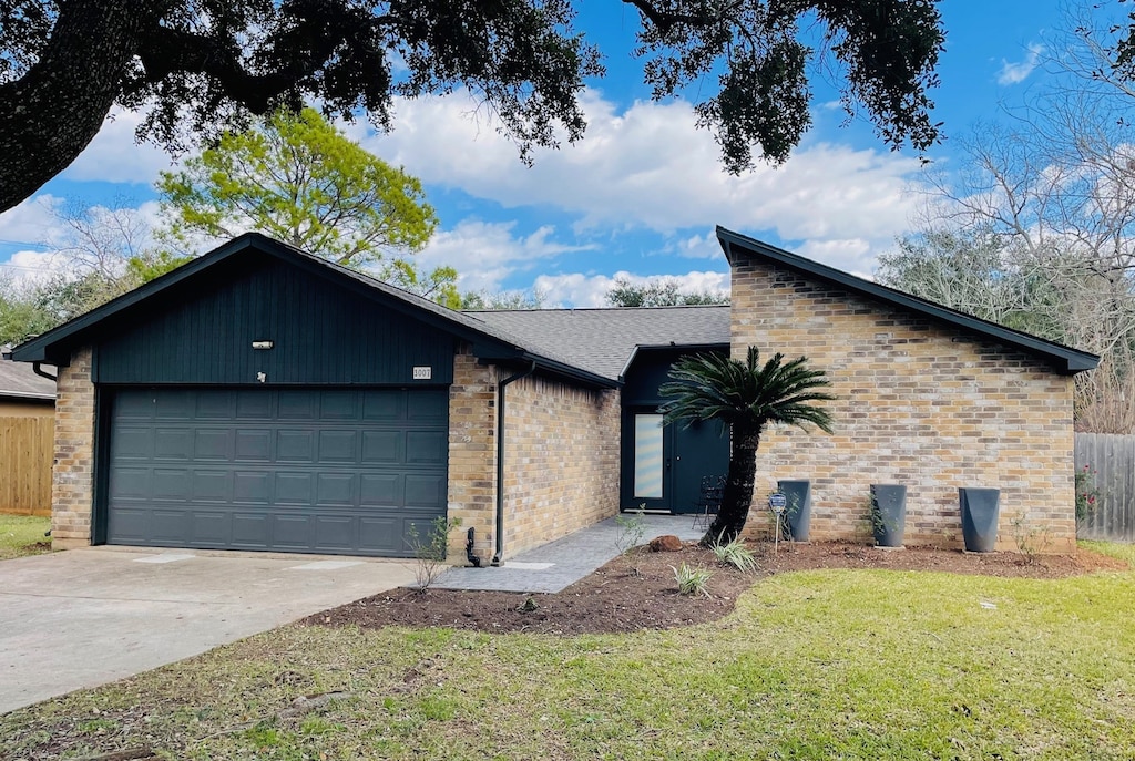 ranch-style home featuring a garage and a front yard