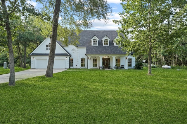 cape cod home with a porch, a garage, and a front yard