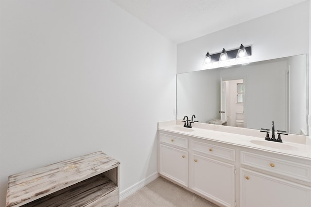 bathroom with toilet and vanity