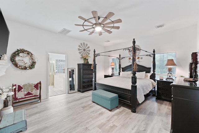 bedroom with ceiling fan, ensuite bathroom, and light hardwood / wood-style flooring