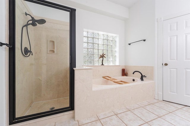 bathroom with tile patterned floors and independent shower and bath