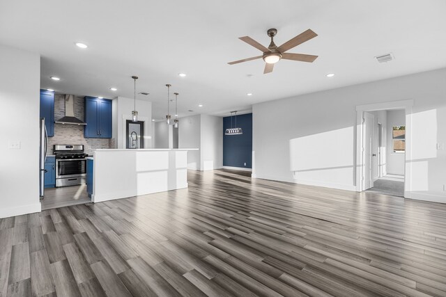 unfurnished living room with visible vents, dark wood finished floors, and recessed lighting