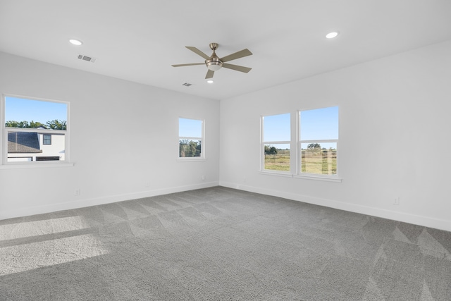 spare room with recessed lighting, baseboards, visible vents, and carpet flooring