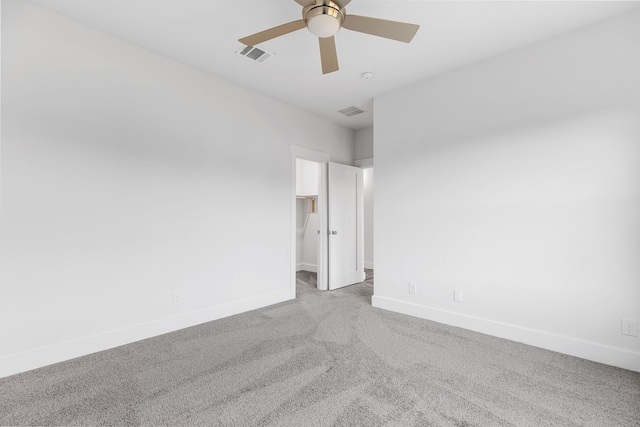 unfurnished room with light carpet, a ceiling fan, visible vents, and baseboards