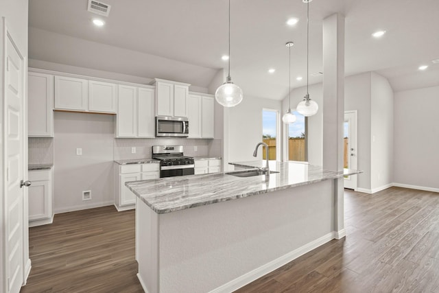 kitchen with sink, white cabinets, decorative light fixtures, and appliances with stainless steel finishes