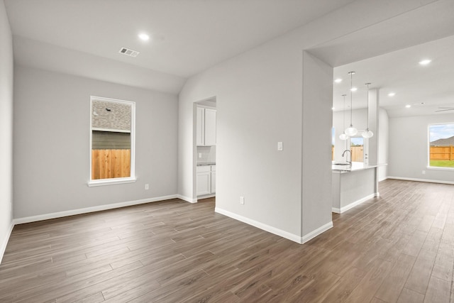 spare room featuring sink and dark hardwood / wood-style flooring