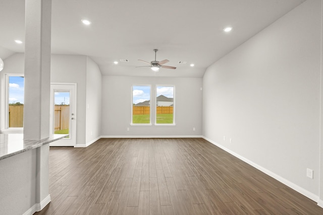 unfurnished living room featuring lofted ceiling, dark hardwood / wood-style floors, and ceiling fan