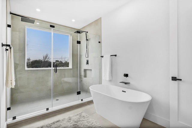 bathroom featuring separate shower and tub