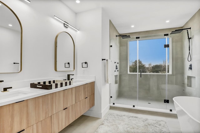 bathroom with vanity and independent shower and bath