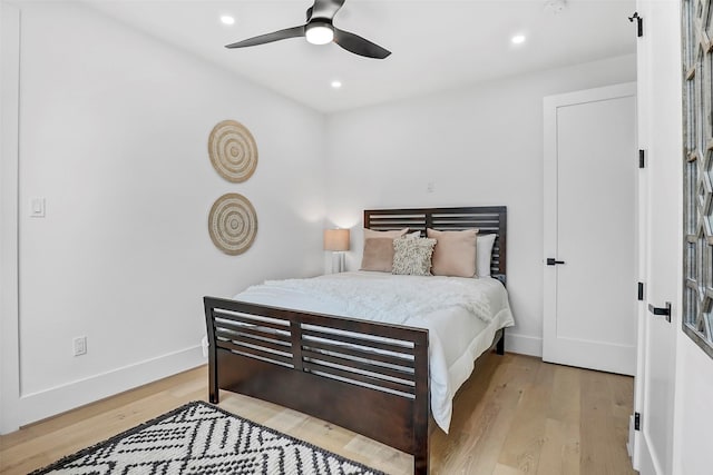 bedroom with ceiling fan and light wood-type flooring