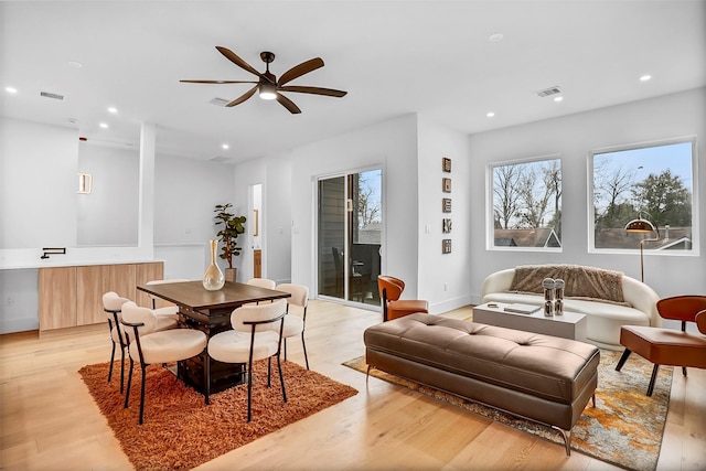 dining room with light hardwood / wood-style floors and ceiling fan