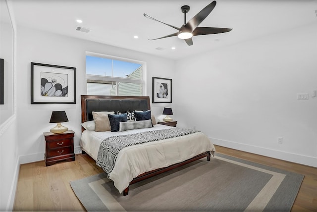 bedroom with light hardwood / wood-style floors and ceiling fan