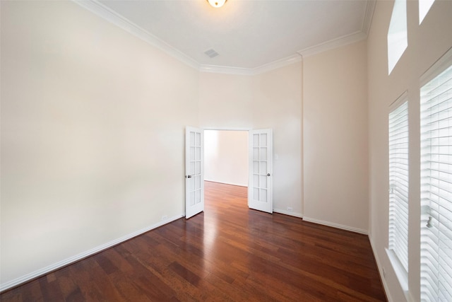 spare room with crown molding and dark wood-type flooring