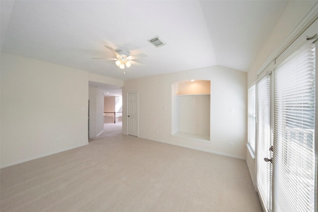 unfurnished room with ceiling fan, light colored carpet, and lofted ceiling