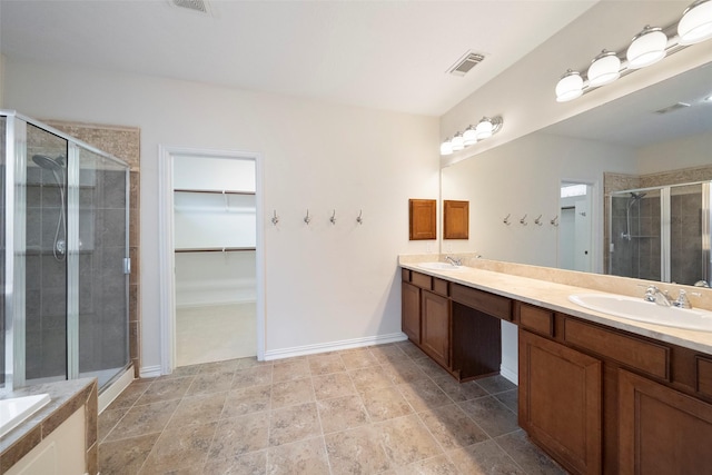 bathroom featuring walk in shower and vanity