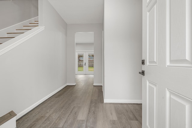 hallway with french doors and light wood-type flooring