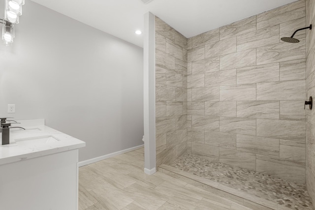 bathroom featuring vanity and a tile shower