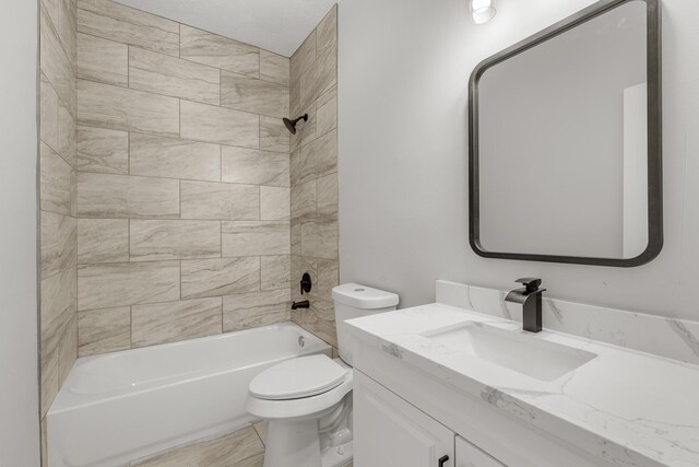 full bathroom with vanity, toilet, and tiled shower / bath combo