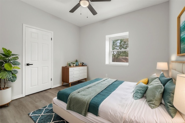 bedroom with ceiling fan and light hardwood / wood-style flooring