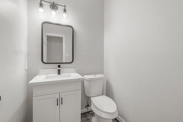 bathroom with toilet and vanity