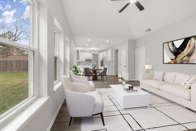 living room featuring ceiling fan, light hardwood / wood-style flooring, and lofted ceiling