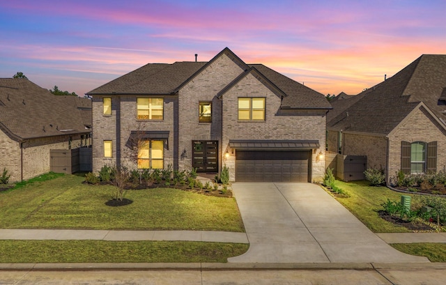 french provincial home featuring a garage and a lawn