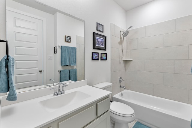 full bathroom with vanity, toilet, and tiled shower / bath