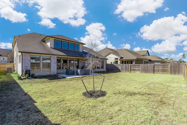 rear view of house with cooling unit, a lawn, and a patio