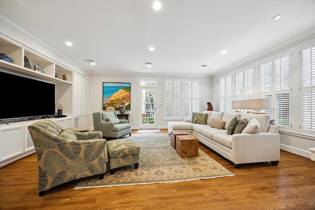 living room featuring hardwood / wood-style floors and crown molding