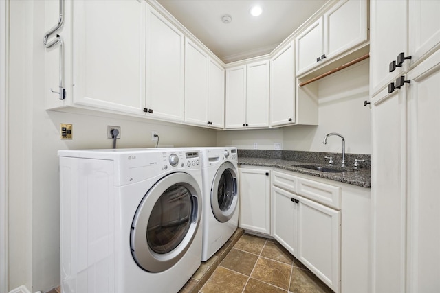 washroom with cabinets, sink, and washer and clothes dryer