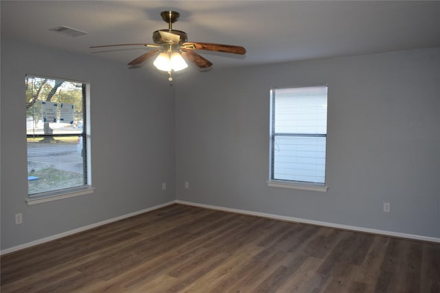 spare room featuring ceiling fan and dark hardwood / wood-style floors