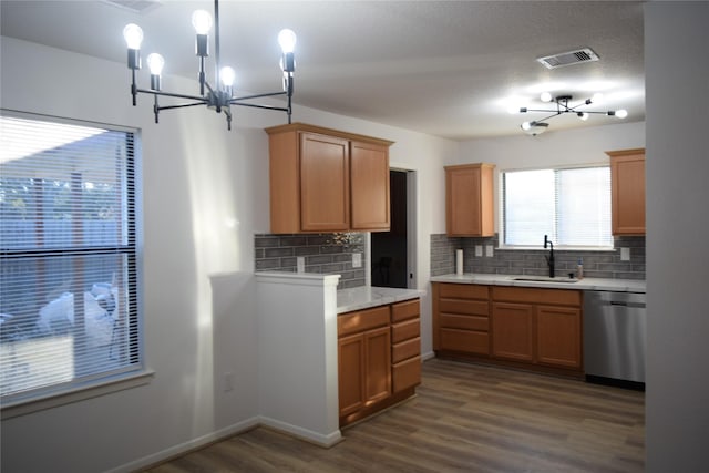 kitchen with dark wood-type flooring, sink, dishwasher, pendant lighting, and backsplash