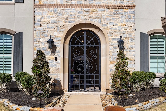 doorway to property featuring stone siding