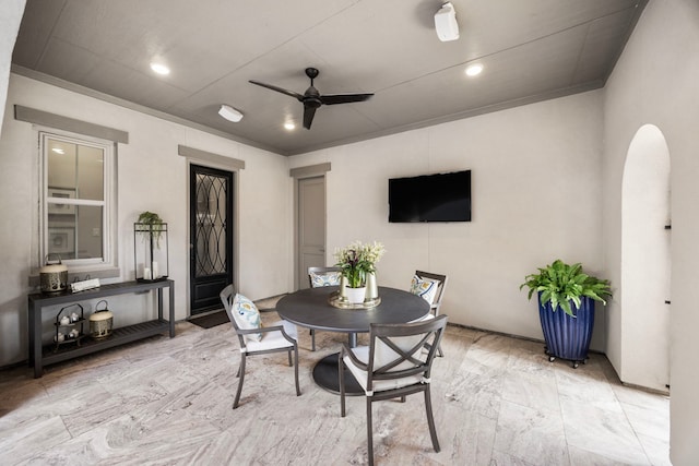 dining room with arched walkways, ceiling fan, and recessed lighting