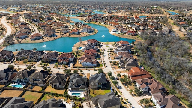 drone / aerial view with a residential view and a water view