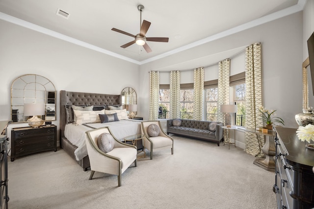 bedroom with light carpet, ornamental molding, visible vents, and a ceiling fan