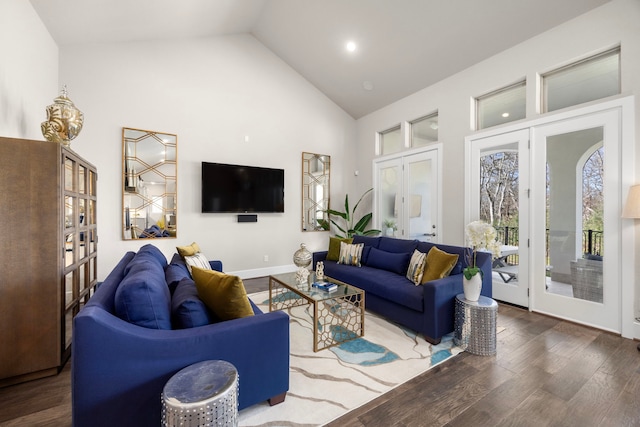 living room featuring dark hardwood / wood-style flooring, high vaulted ceiling, and french doors