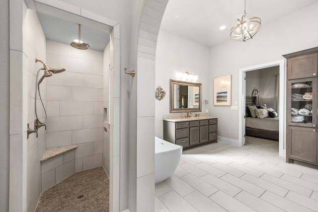 bathroom featuring connected bathroom, vanity, a freestanding bath, walk in shower, and an inviting chandelier