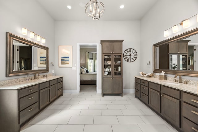 bathroom featuring vanity, a notable chandelier, and tile patterned floors