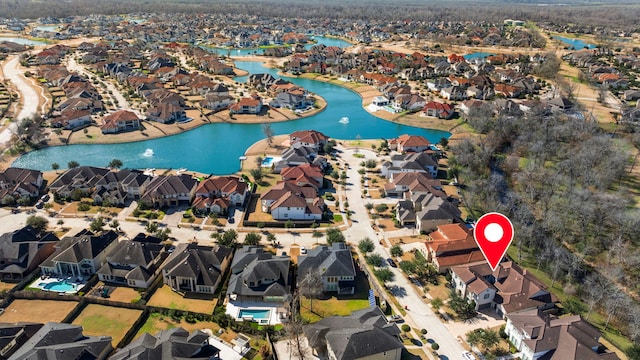 drone / aerial view with a water view and a residential view