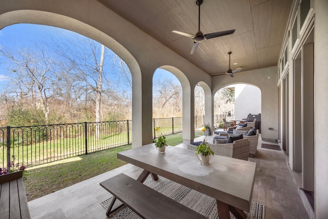 view of patio with an outdoor hangout area, outdoor dining area, a fenced backyard, and a ceiling fan