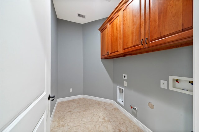 laundry area with hookup for a gas dryer, hookup for a washing machine, hookup for an electric dryer, and cabinets