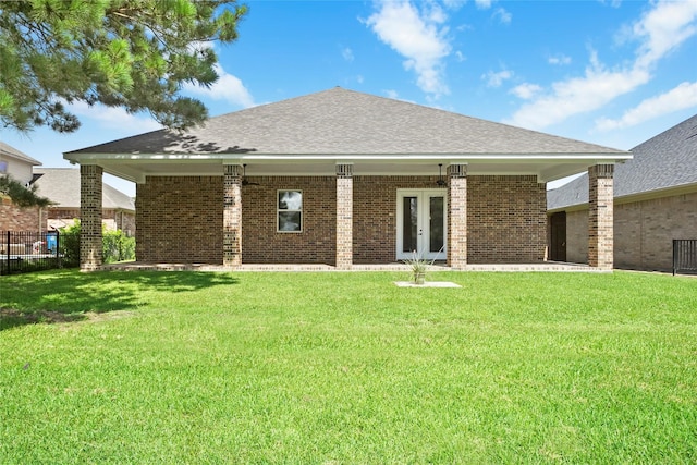 back of house with a lawn and french doors