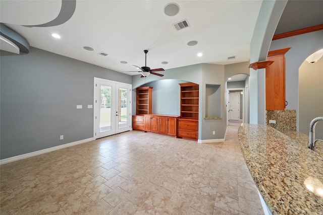 unfurnished living room with ceiling fan