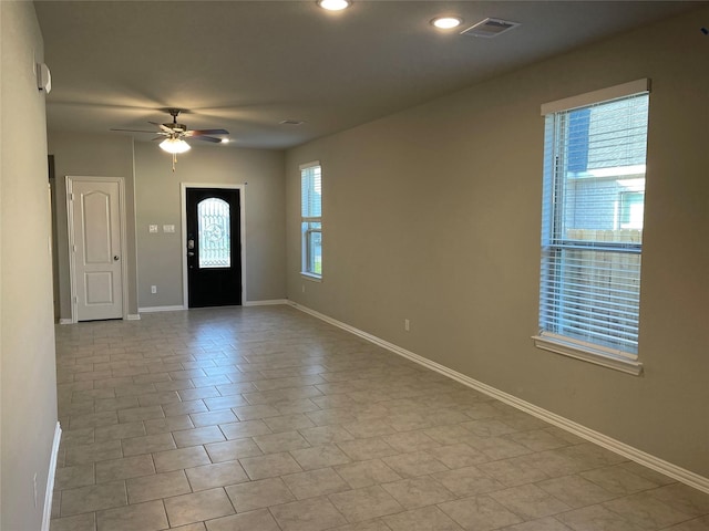 tiled foyer entrance with ceiling fan