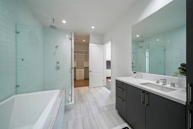 bathroom featuring vanity and shower with separate bathtub