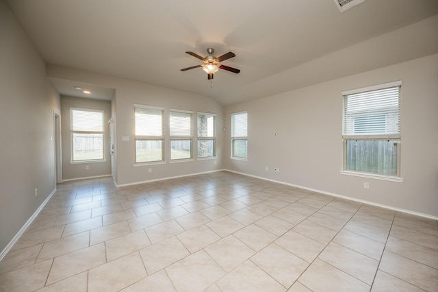 spare room with ceiling fan, lofted ceiling, and light tile patterned flooring